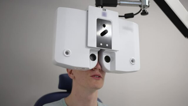 Doctor checks patient eyes using autoref keratometer. Laser vision correction. 