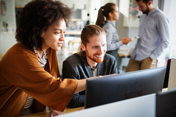Programmers cooperating at IT company developing apps