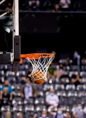 Fotobehang scoring during a basketball game ball in hoop © Melinda Nagy