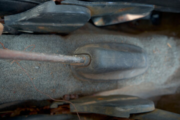 Disassembled vehicle for transportation and transport.horizontal image of the inside of the front of a very old broken down car ,Dirty brake, and accelerator gear shifter pedal of manual
