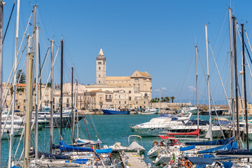 View of a nice fishing harbor and marina in Trani, with San Nicola Pellegrino Cathedral of Trani,...