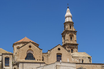 Fototapeta na wymiar The bell tower of Cathedral Basilica of Maria Santissima della Madia in the historic center of Monopoli, Bari, Puglia, Italy