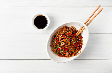 Udon noodles with mushrooms and vegetables, in sauce, with sesame seeds, Asian vegetarian food,...