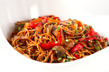 Udon noodles with mushrooms and vegetables, in sauce, with sesame seeds, Asian vegetarian food, horizontal, no people,