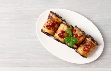 Georgian cuisine, eggplant rolls with nut filling and spices, on a wooden table, horizontal, no people,