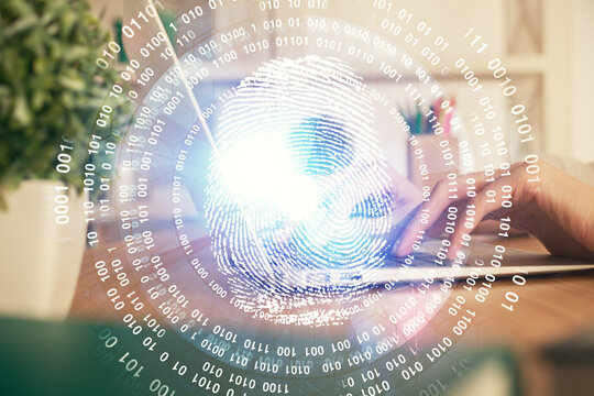 Double exposure of woman hands typing on computer and fingerprint drawing. Security concept.