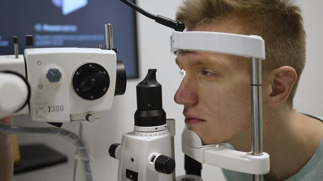 Laser vision correction. Doctor checks patient eyes using autoref keratometer