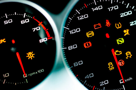 Car dashboard. Checking the system when starting the engine. A close-up of the speedometer and tachometer with additional instruments is illuminated. ..