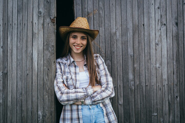 woman rancher standing in front of barn