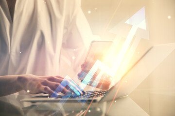 Double exposure of arrows hologram and woman holding and using a mobile device. Success concept.