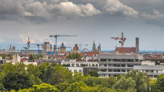 Aerial view of a europe city under construction with huge cranes timelapse, munich city sklyline view downtown panoramic view.