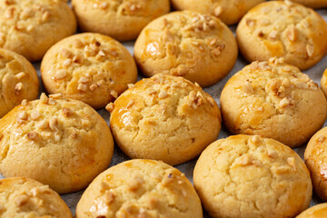 Homemade Norwegian butter cookies with almonds are laid out on a light gray culinary background. Traditional Scandinavian pastries close-up. Wallpaper