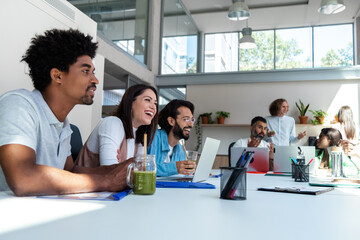 Diverse group of coworkers at the office sharing news. Talking. Copy space.