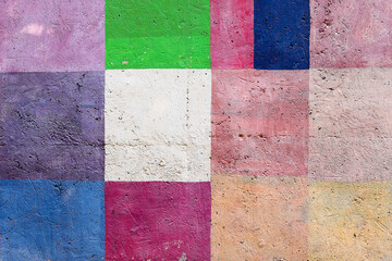 The concrete wall is painted in bright colors.
