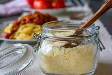 Parmesan cheese in a jar on kitchen table