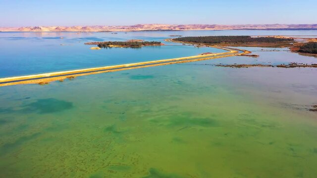 Aerial Forward Scenic View Of Lake Against Clear Sky On Sunny Day - Siwa Oasis, Egypt