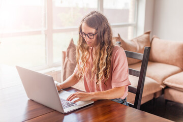 Cheerful woman using silver laptop