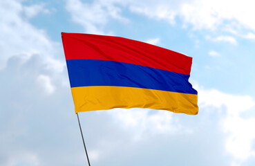 Flag of Armenia, realistic 3d rendering in front of blue sky 