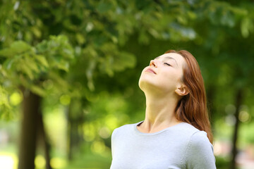 Beautiful woman breathing fresh air in a park