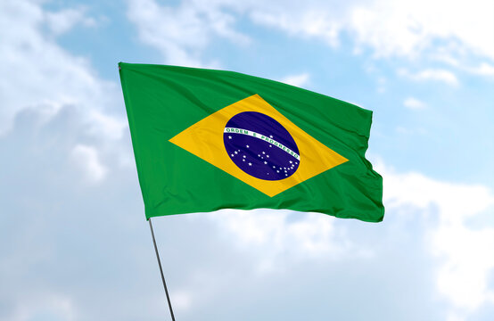 Flag of Brazil, realistic 3d rendering in front of blue sky