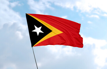 Flag of East Timor, realistic 3d rendering in front of blue sky