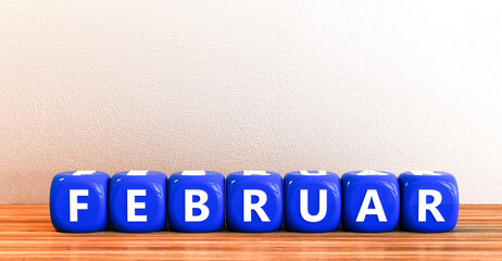 Februar als Wort mit Würfeln vor leerer Wand