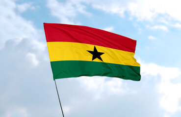 Flag of Ghana, realistic 3d rendering in front of blue sky