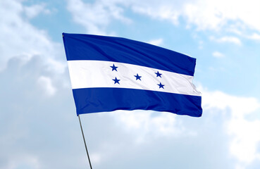 Flag of Honduras, realistic 3d rendering in front of blue sky