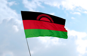 Flag of Malawi, realistic 3d rendering in front of blue sky