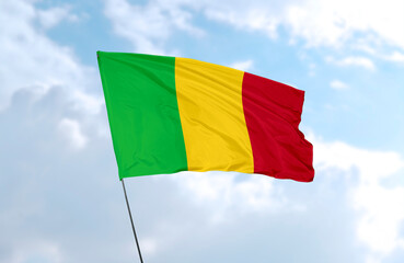 Flag of Mali, realistic 3d rendering in front of blue sky