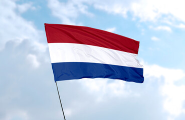 Flag of Netherlands, realistic 3d rendering in front of blue sky