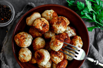 Chicken meatballs in a plate. Meatballs and basil. Copyspace. Top view.