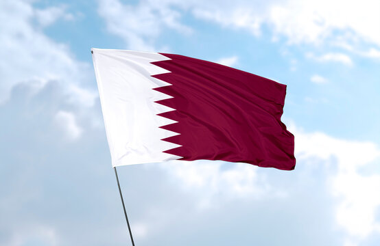Flag of Qatar, realistic 3d rendering in front of blue sky