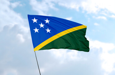 Flag of Solomon Islands, realistic 3d rendering in front of blue sky