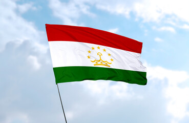 Flag of Tajikistan, realistic 3d rendering in front of blue sky