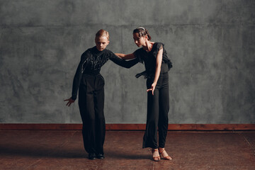 Young caucasian professional dancers dancing in ballroom pasodoble