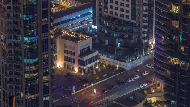 Aerial view of a road intersection between skyscrapers in a big city timelapse.