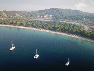 Areal view of Koukounaries beach at Skiathos and three sailboats