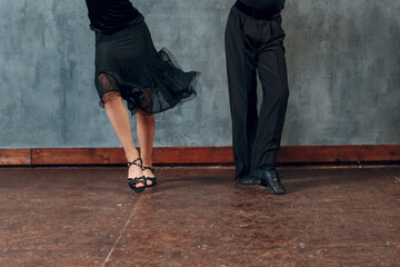 Legs of young couple boy and girl dancing in ballroom dance Jive.
