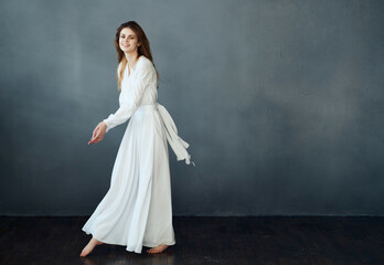 Fototapeta na wymiar portrait of woman in white dress in full growth dance glamor isolated background