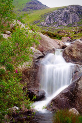 Fototapeta na wymiar Mountain stream waterfall flows into Llyn Ogwen, North Wales