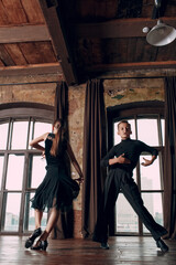 Young couple boy and girl dancing in ballroom dance Rumba.