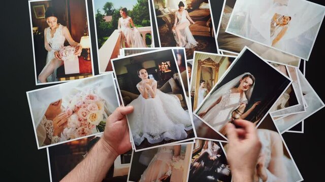 hands lay out wedding photos. the result of the photographer's work at wedding.