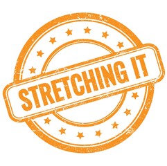 STRETCHING IT text on orange grungy round rubber stamp.