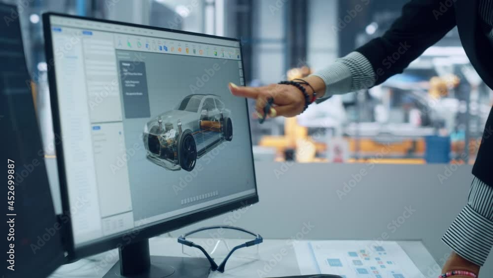 Poster two automotive engineers discussing concept car blueprints on desktop computer in modern office at a