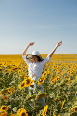 woman dancing in a field of sunflowers