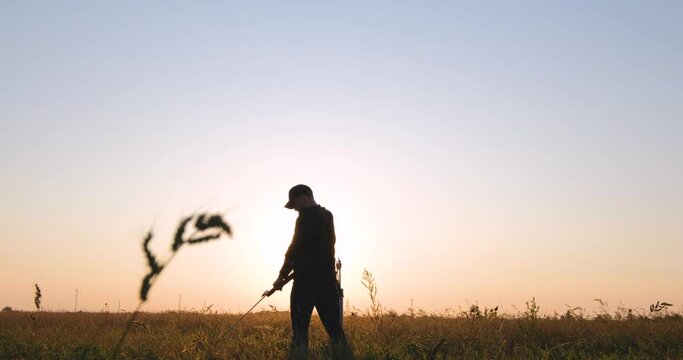 Man with bow outdoors in the field