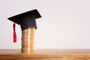 Black Graduation cap over stack of coins