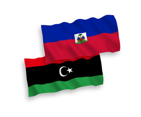 Fototapeta premium National vector fabric wave flags of Republic of Haiti and Libya isolated on white background. 1 to 2 proportion.