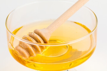 Honey ladle. Honey tidbit in a glass jar